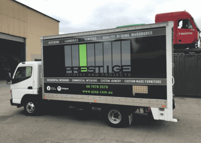 A delivery tuck that has a vehicle wrap style large format sign which is a reproduction of the company's website