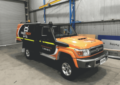 A purpose built service van with sign writing promoting the companies name and corporate colours