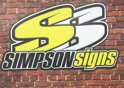 An example of a free form vinyl cut sign mounted on raw bricks