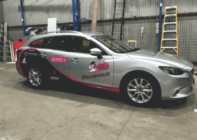 A car body wrap that was designed as a promotional sign for a sporting team