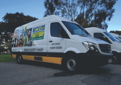 A safety equipment delivery van featuring large format printed signs and vinyl cut words applied to the side the van