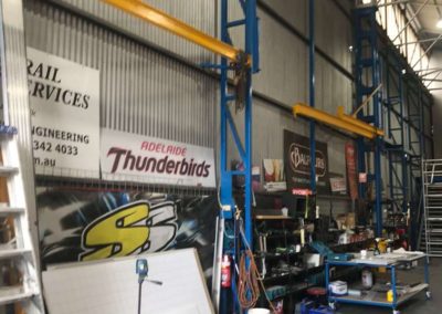 The workshop is very tall with ladders, scaffolding and mobile desks and trolleys to make the fixing of signs and sign writing on trucks and buses more accessible
