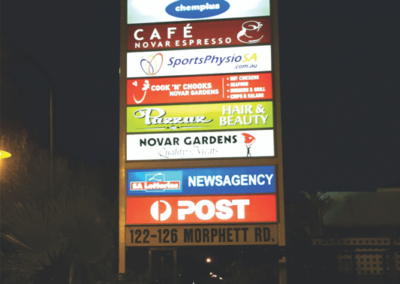An outside pylon sign with back lit panels for shopping centre