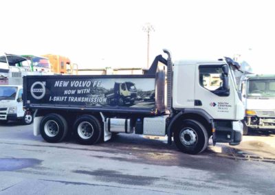 A Tandem trailer tipper, with a large format digital sign applied to the back of the truck and the companies name and logo applied via a vinyl sign to the cabin